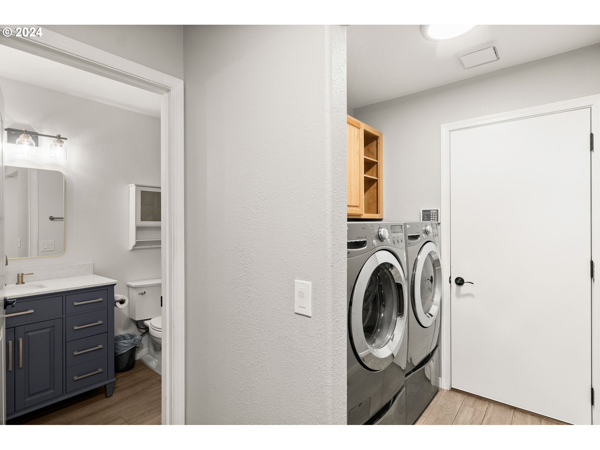 216 Southwest Sutherland Way Beaverton, OR 97006 - Photo 16 of 19 a bathroom with a sink a washer and dryer