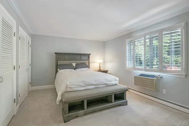 a bed sitting in a bedroom next to a window