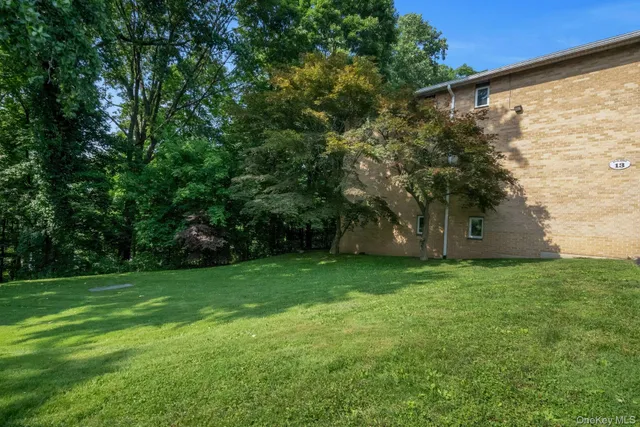 a sign that is sitting on a wooden fence