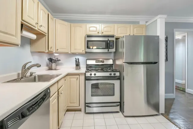 a kitchen with stainless steel appliances granite countertop a refrigerator stove and sink