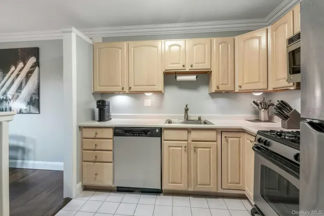 a kitchen with cabinets appliances and a window