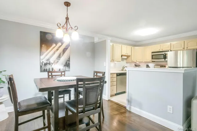 a kitchen with kitchen island a stove a table and chairs in it