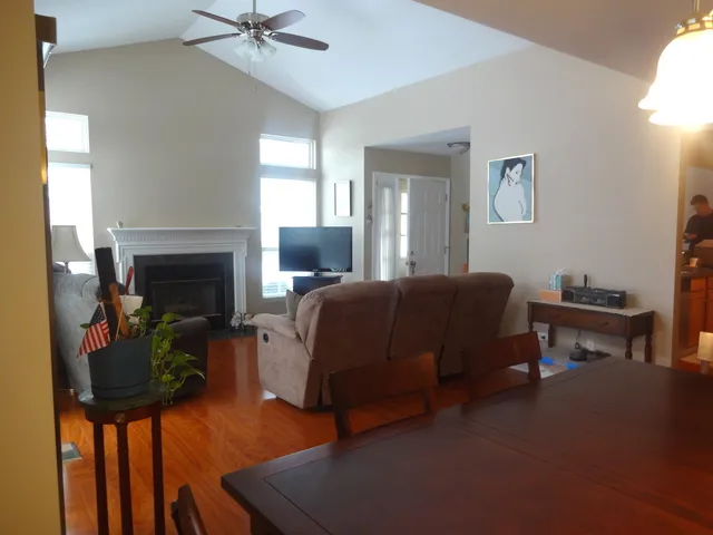 a view of a dining room with furniture and wooden floor