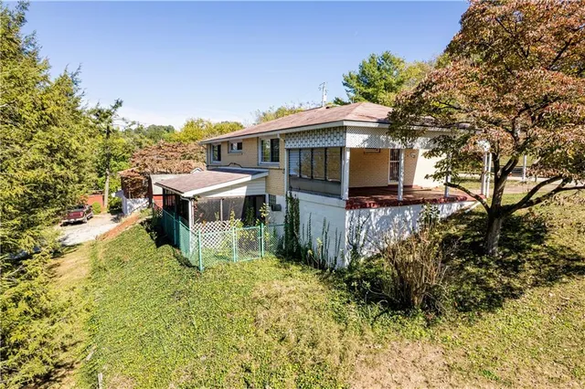 a view of a house with pool and sitting area