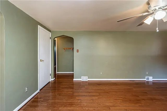 a view of a room with wooden floor