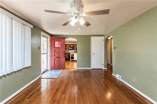 wooden floor in an empty room with a window