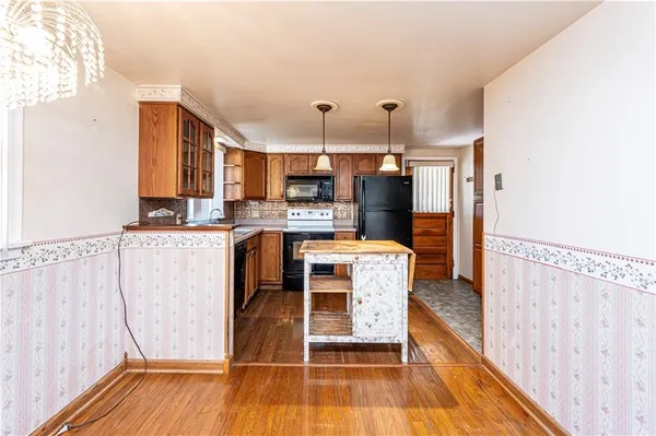 a kitchen view with stainless steel appliances a stove top oven and cabinets