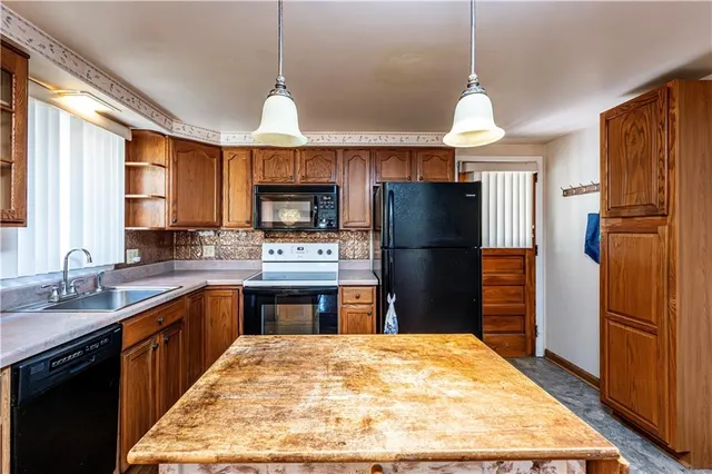 a kitchen with refrigerator cabinets and a sink