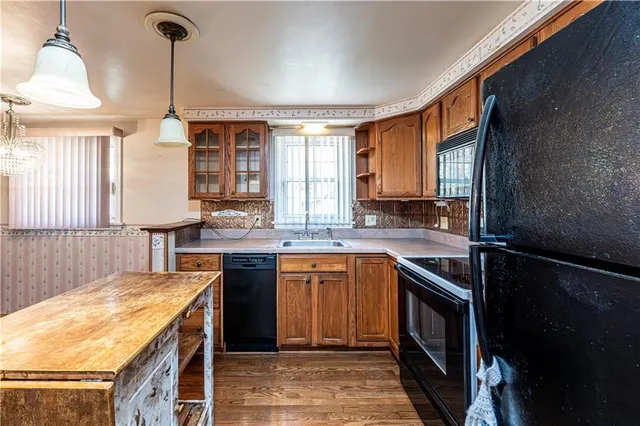 a kitchen with a sink and a refrigerator