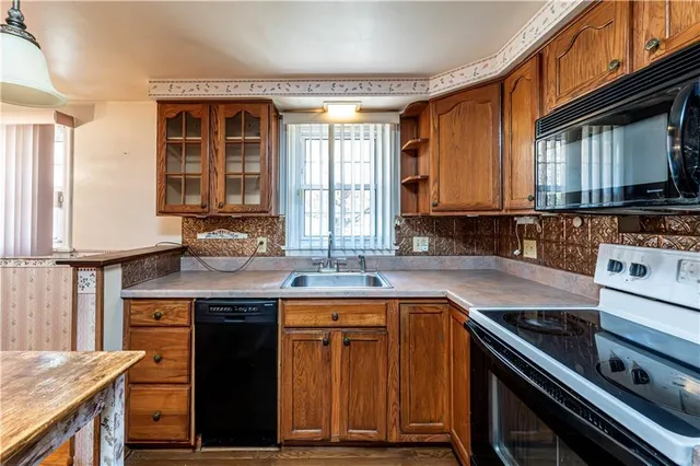 a kitchen with a sink stove top oven and cabinets