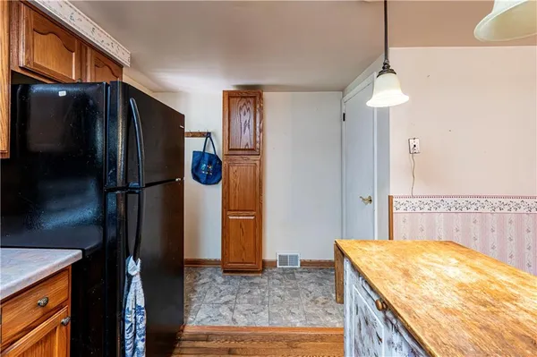 a kitchen with refrigerator and window