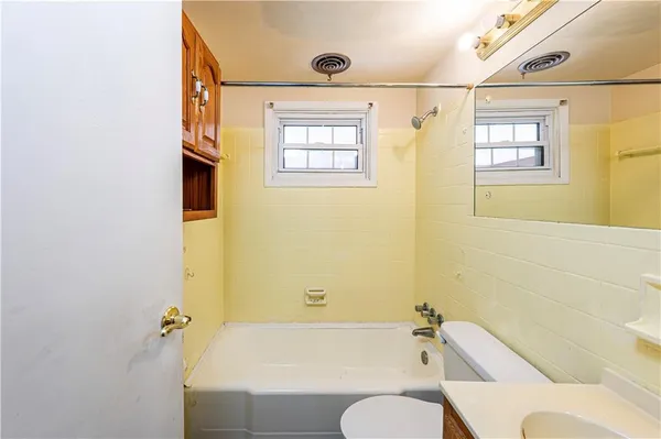 a bathroom with a bathtub and shower