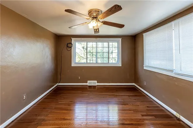 wooden floor in an empty room with a window