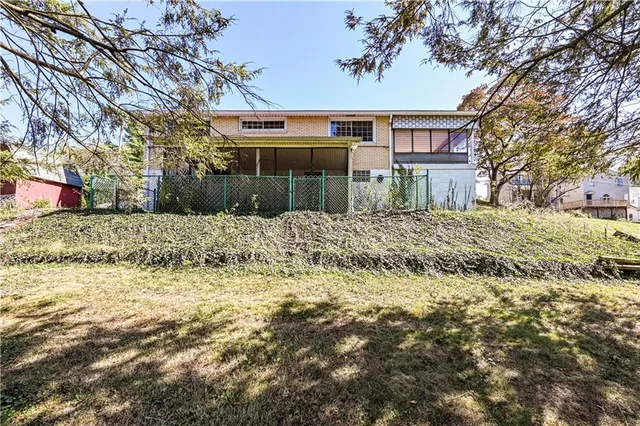 a view of a house with a yard covered in snow