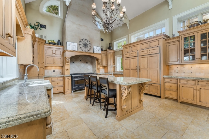312 Hamden Road Annandale, NJ 08801 - Photo 27 of 50 a kitchen with stainless steel appliances granite countertop a stove top oven a sink a dining table and chairs with wooden floor