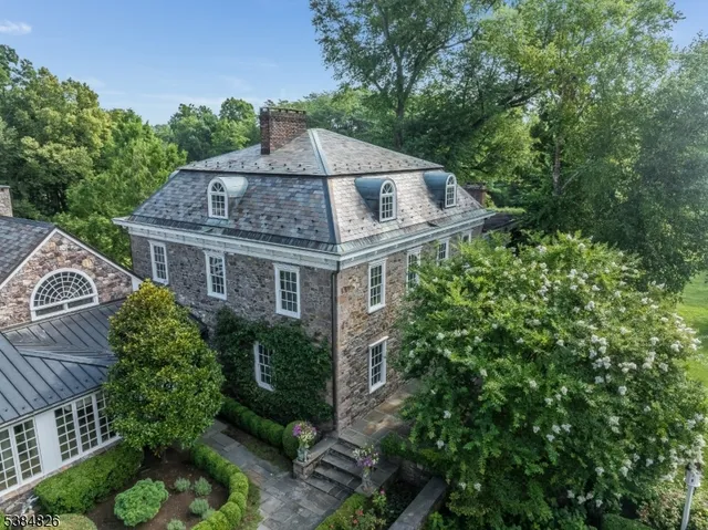 a house with a big yard plants and large trees