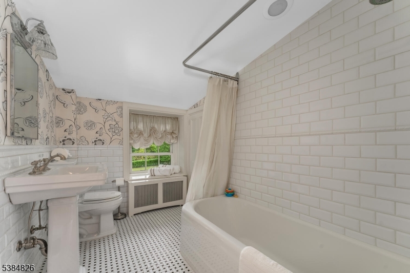 312 Hamden Road Annandale, NJ 08801 - Photo 42 of 50 a bathroom with a sink a toilet a mirror a bathtub and shower