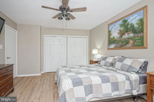 a bedroom with a bed and a painting on the wall