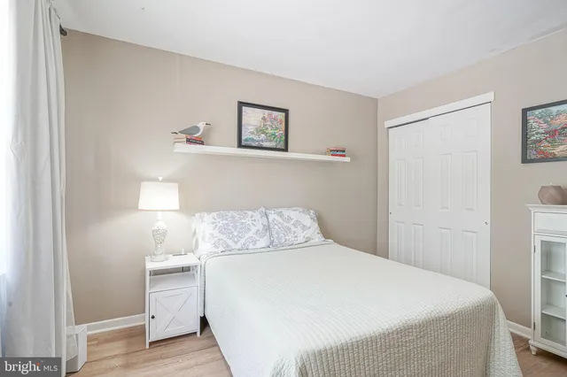 a bedroom with a bed and a night stand