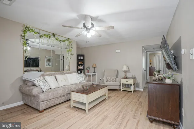 a living room with furniture and a large mirror