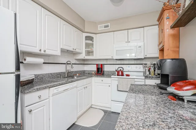 a kitchen with a sink cabinets and window