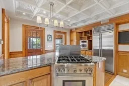 a kitchen with a stove and a chandelier