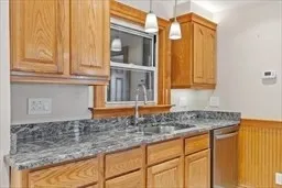 a kitchen with granite countertop a sink and cabinets