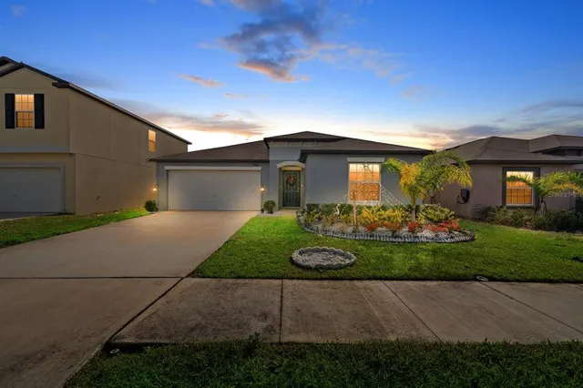 a kitchen with stainless steel appliances granite countertop a sink a stove a refrigerator cabinets and chairs