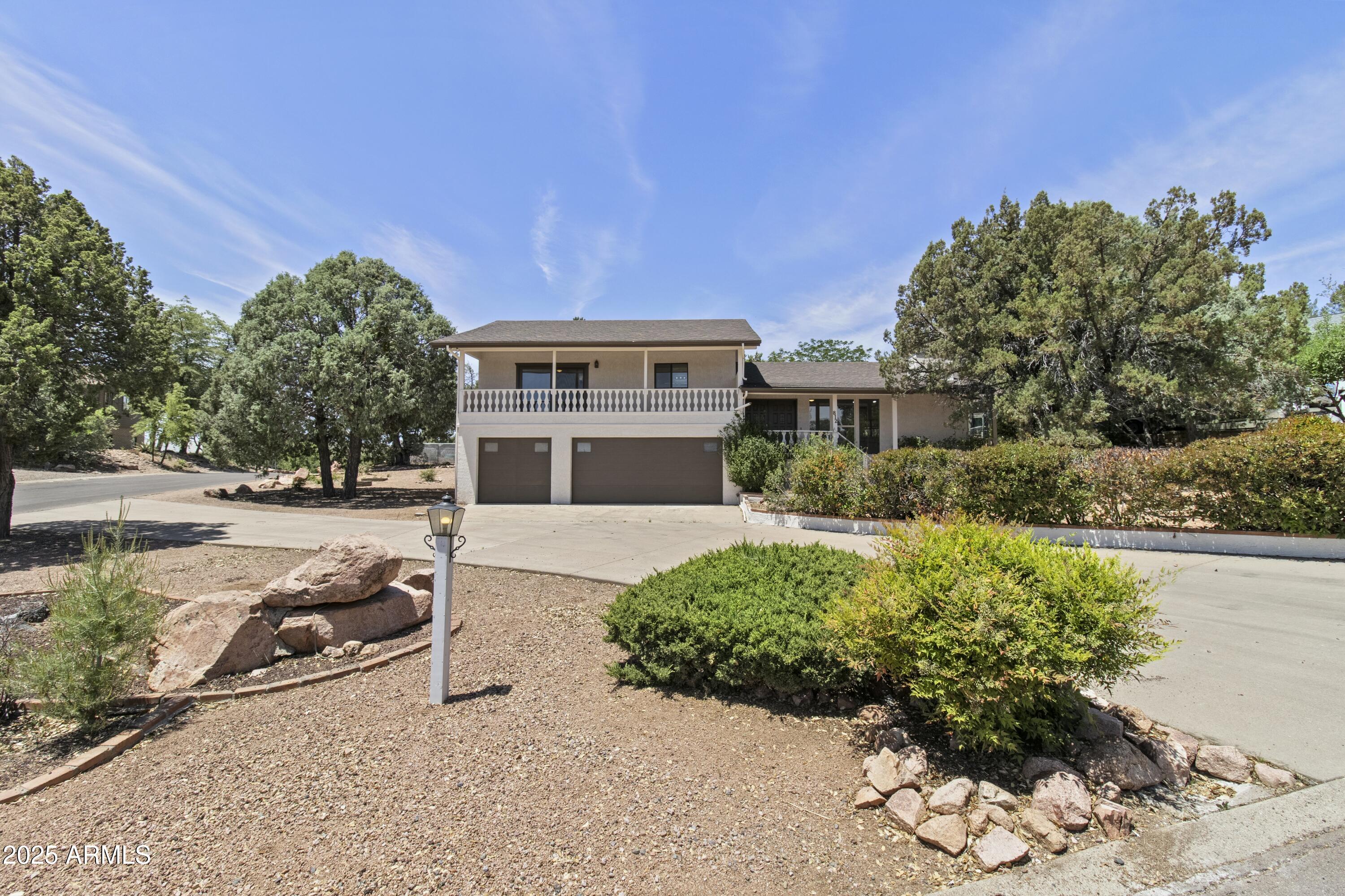 a view of a house with a yard and a garden