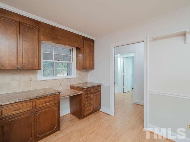 2205 Barfield Court Raleigh, NC 27612 - Photo 11 of 30 a kitchen with stainless steel appliances granite countertop a sink stove and cabinets