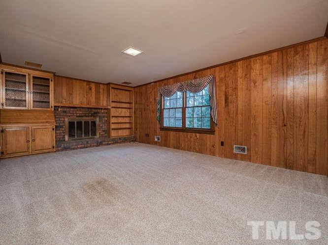 2205 Barfield Court Raleigh, NC 27612 - Photo 13 of 30 an empty room with furniture and a fireplace