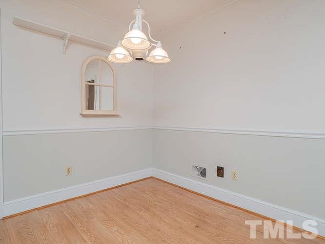 2205 Barfield Court Raleigh, NC 27612 - Photo 14 of 30 a view of a room that has a chandelier fan