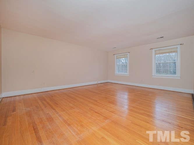 2205 Barfield Court Raleigh, NC 27612 - Photo 15 of 30 a view of an empty room with wooden floor and a window