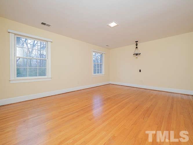 2205 Barfield Court Raleigh, NC 27612 - Photo 17 of 30 wooden floor in an empty room with a window