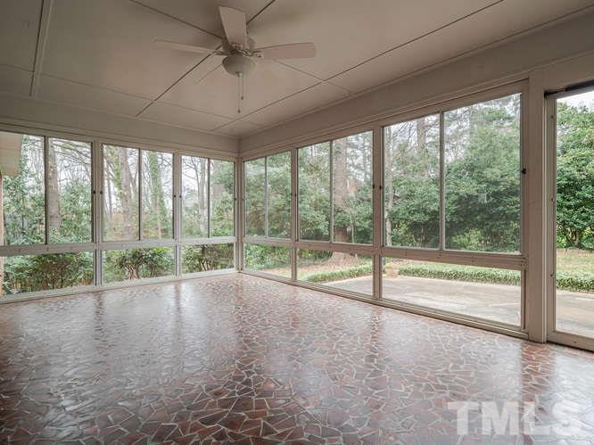 2205 Barfield Court Raleigh, NC 27612 - Photo 3 of 30 a view of an empty room with wooden floor and a floor to ceiling window