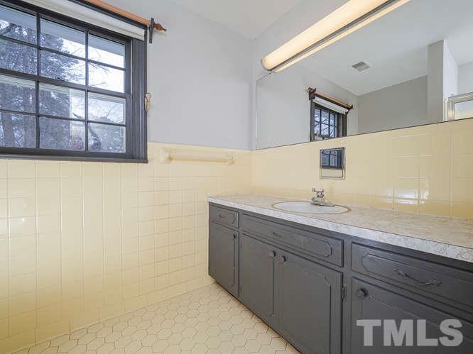 2205 Barfield Court Raleigh, NC 27612 - Photo 23 of 30 a bathroom with a sink and a mirror