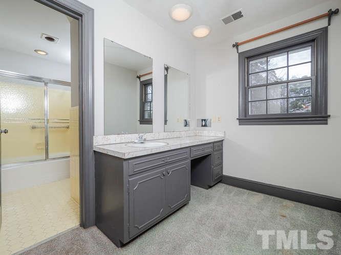 2205 Barfield Court Raleigh, NC 27612 - Photo 24 of 30 a bathroom with a sink and a mirror