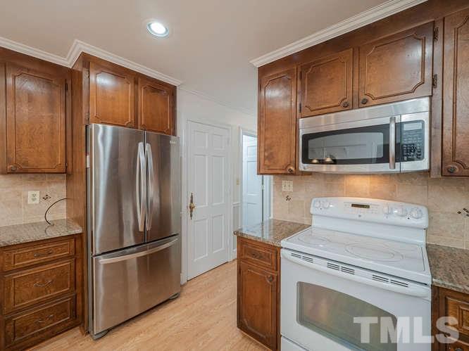2205 Barfield Court Raleigh, NC 27612 - Photo 10 of 30 a kitchen with stainless steel appliances granite countertop a refrigerator stove and microwave