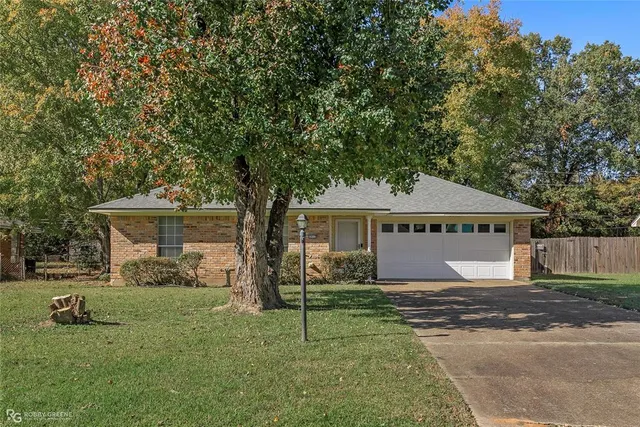 a backyard of a house with yard and outdoor seating