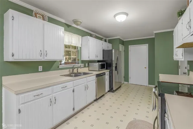 a kitchen with a sink stove and cabinets