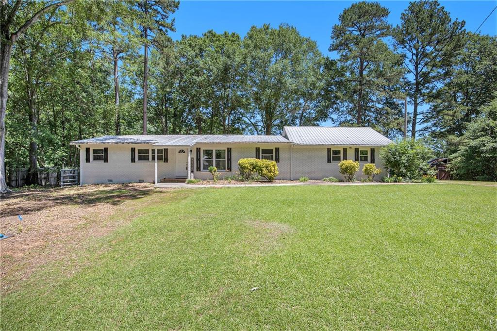 a front view of a house with yard and green space