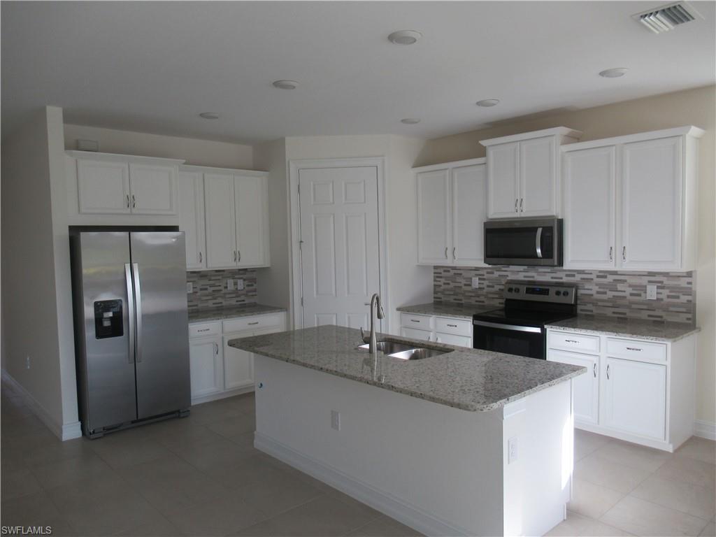 4114 Dutchess Park Road Fort Myers, FL 33916 - Photo 3 of 15 a kitchen with stainless steel appliances granite countertop a sink and a refrigerator