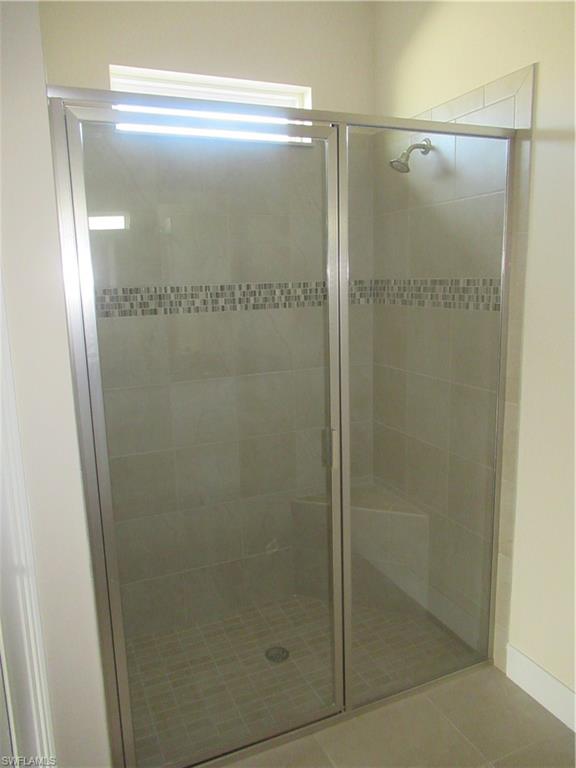 4114 Dutchess Park Road Fort Myers, FL 33916 - Photo 8 of 15 a bathroom with a glass shower door