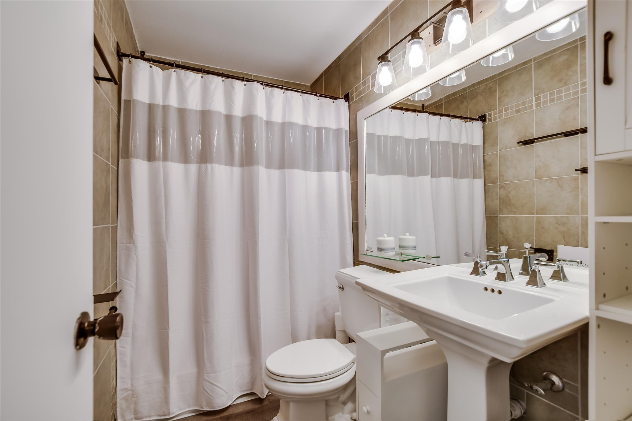 11901 Swearingen Drive, Unit 4 Austin, TX 78758 - Photo 11 of 23 a bathroom with a sink a toilet and a mirror