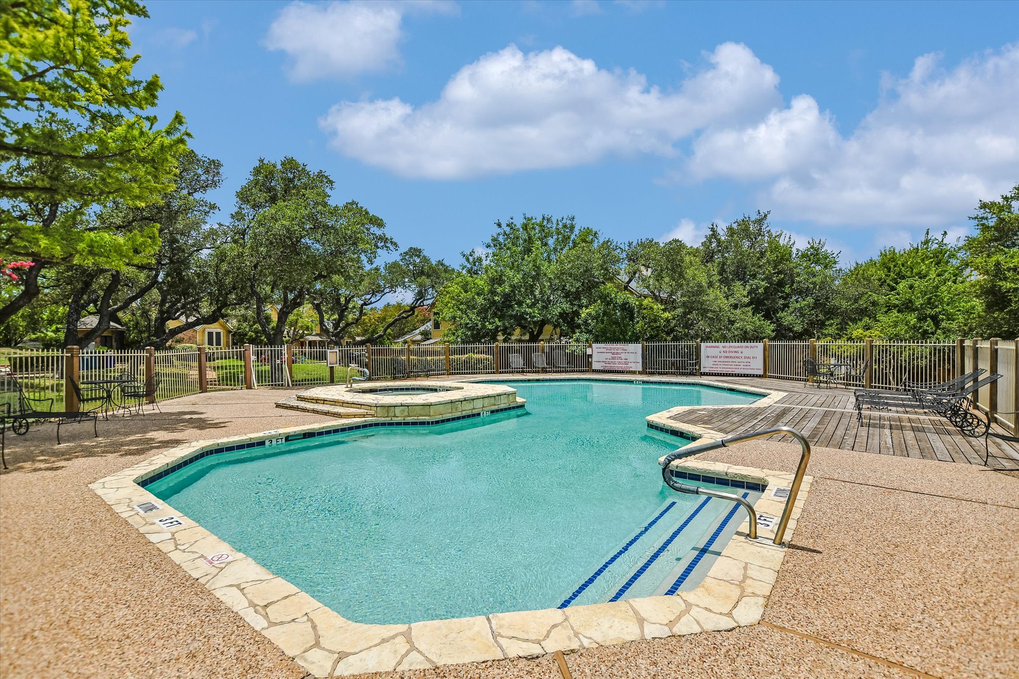 11901 Swearingen Drive, Unit 4 Austin, TX 78758 - Photo 18 of 23 a view of a swimming pool with a lounge chair