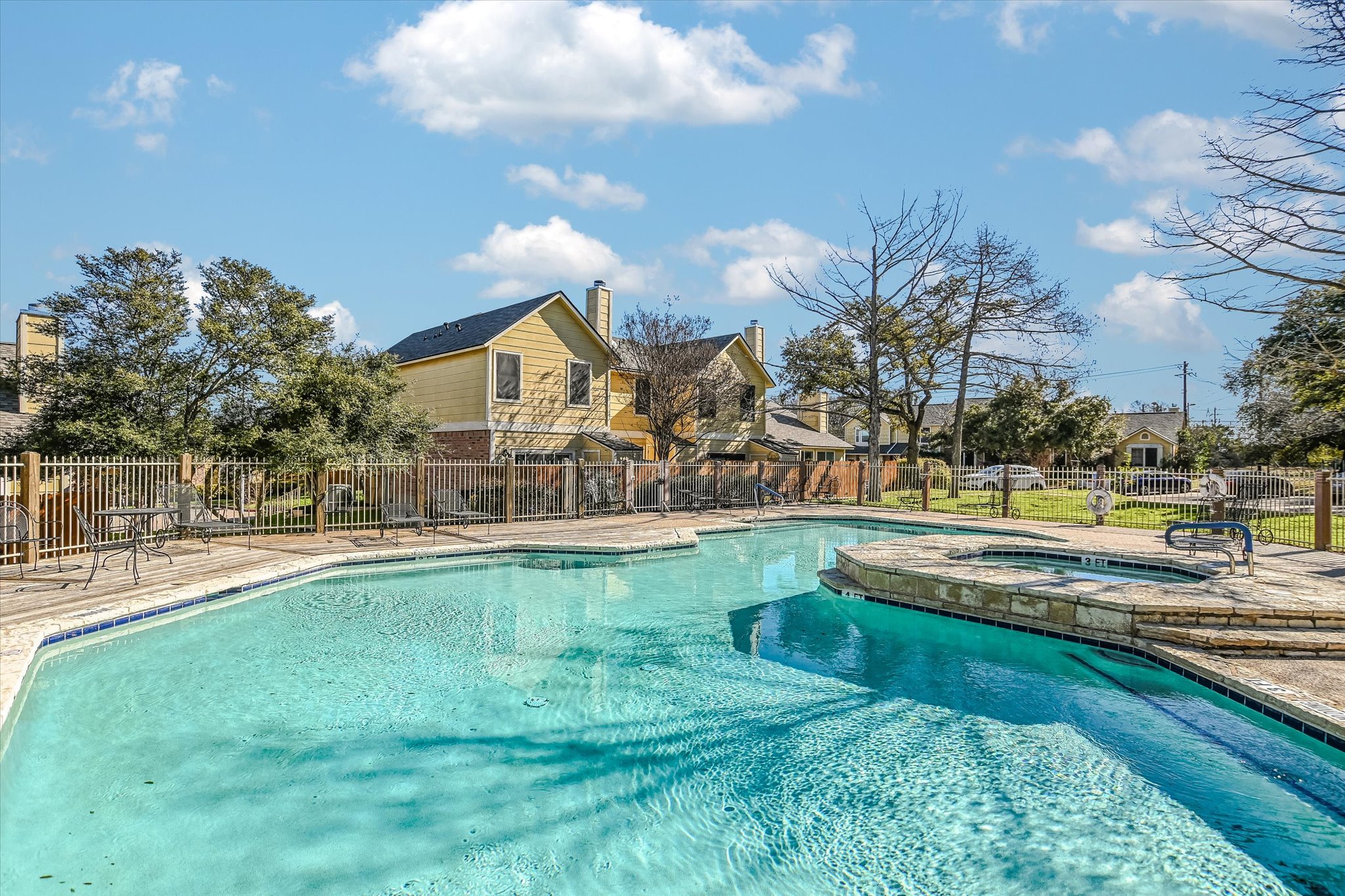 11901 Swearingen Drive, Unit 4 Austin, TX 78758 - Photo 19 of 23 a view of a swimming pool and a yard