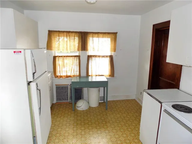a kitchen with a refrigerator and a stove