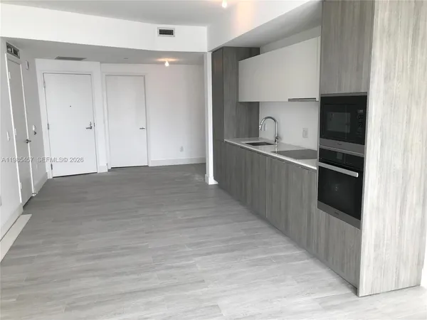 a kitchen with granite countertop a sink and cabinets