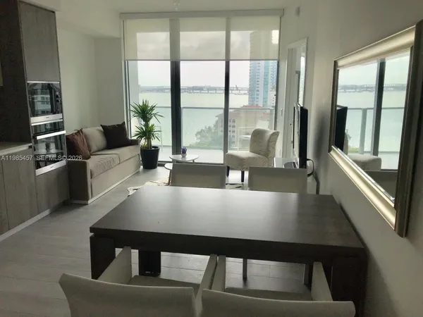 a living room with furniture and a large window