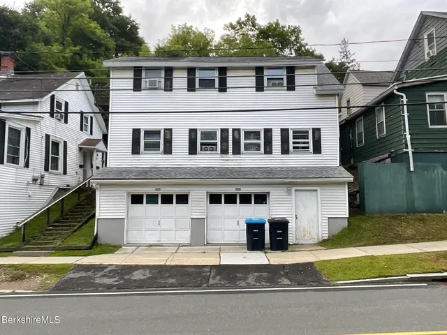 a big house with a large window and large parking space